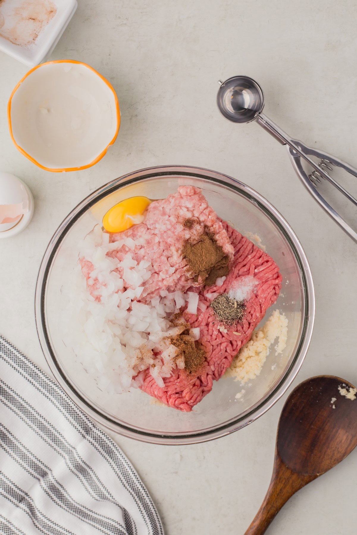 All meatball ingredients added to a bowl. 