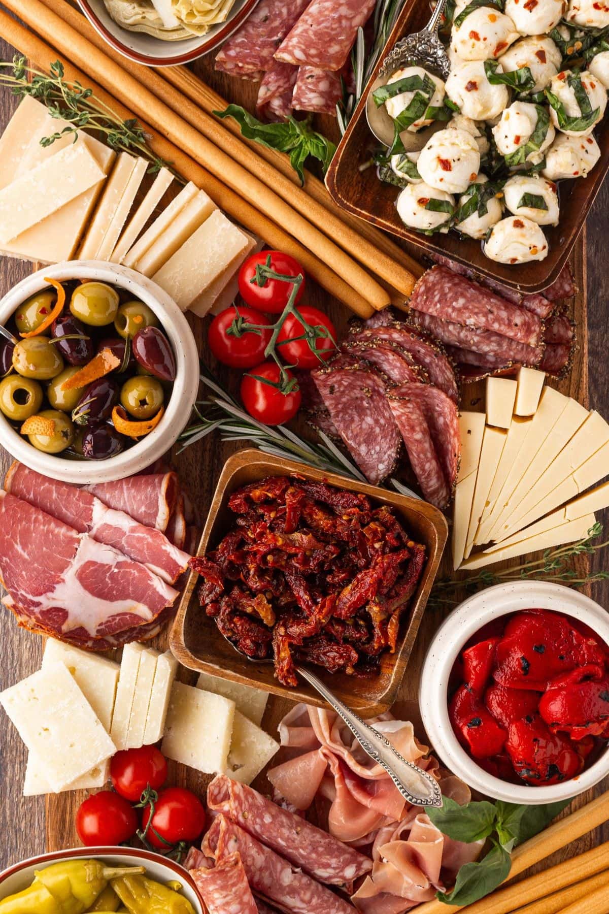 Antipasto platter with small bowls on a serving tray.