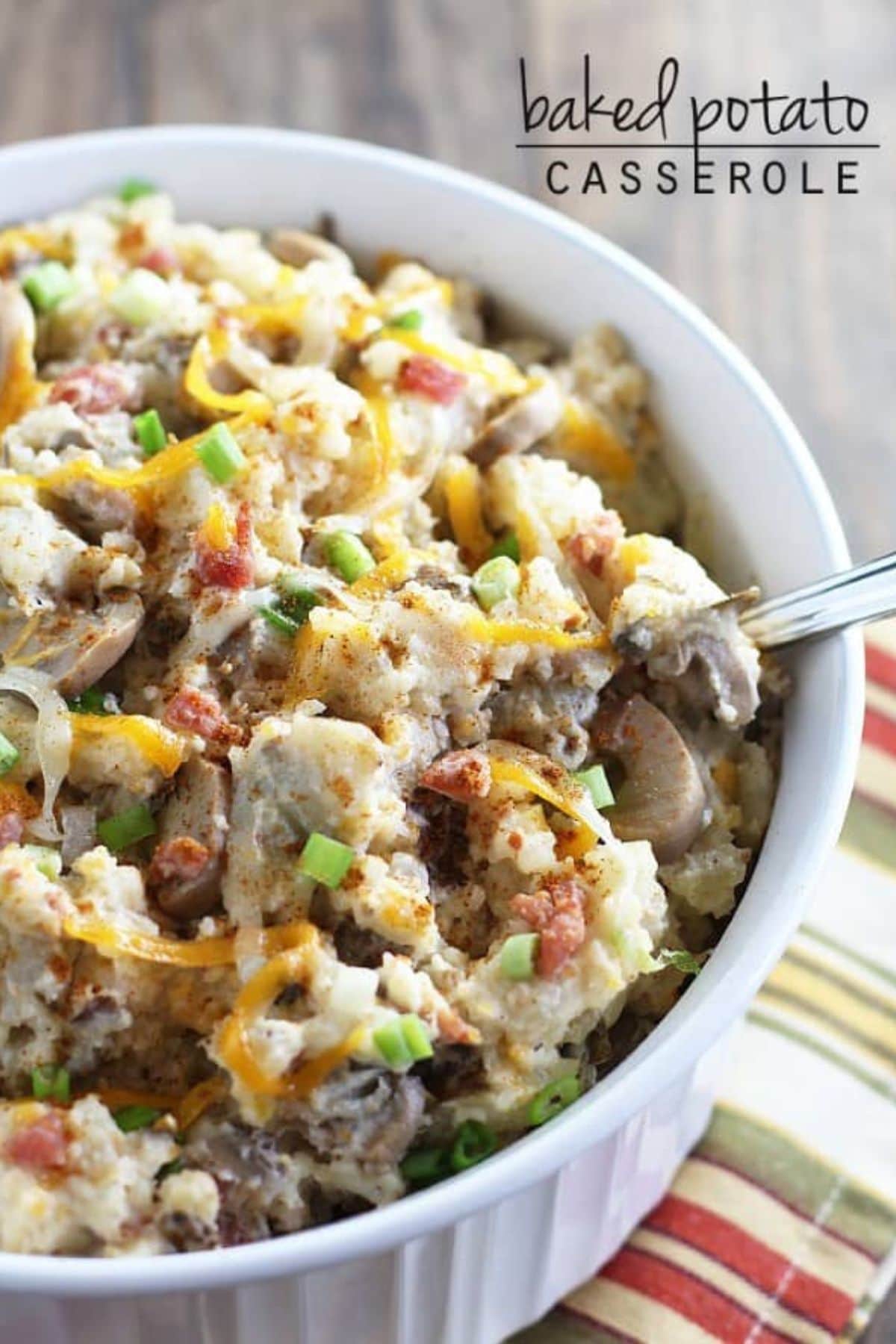 Bowl full of baked potato casserole on a counter ready to serve.