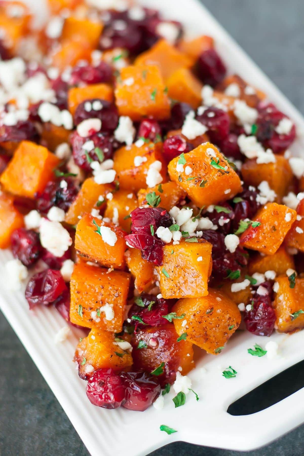 Butternut squash and cranberries on a serving platter.