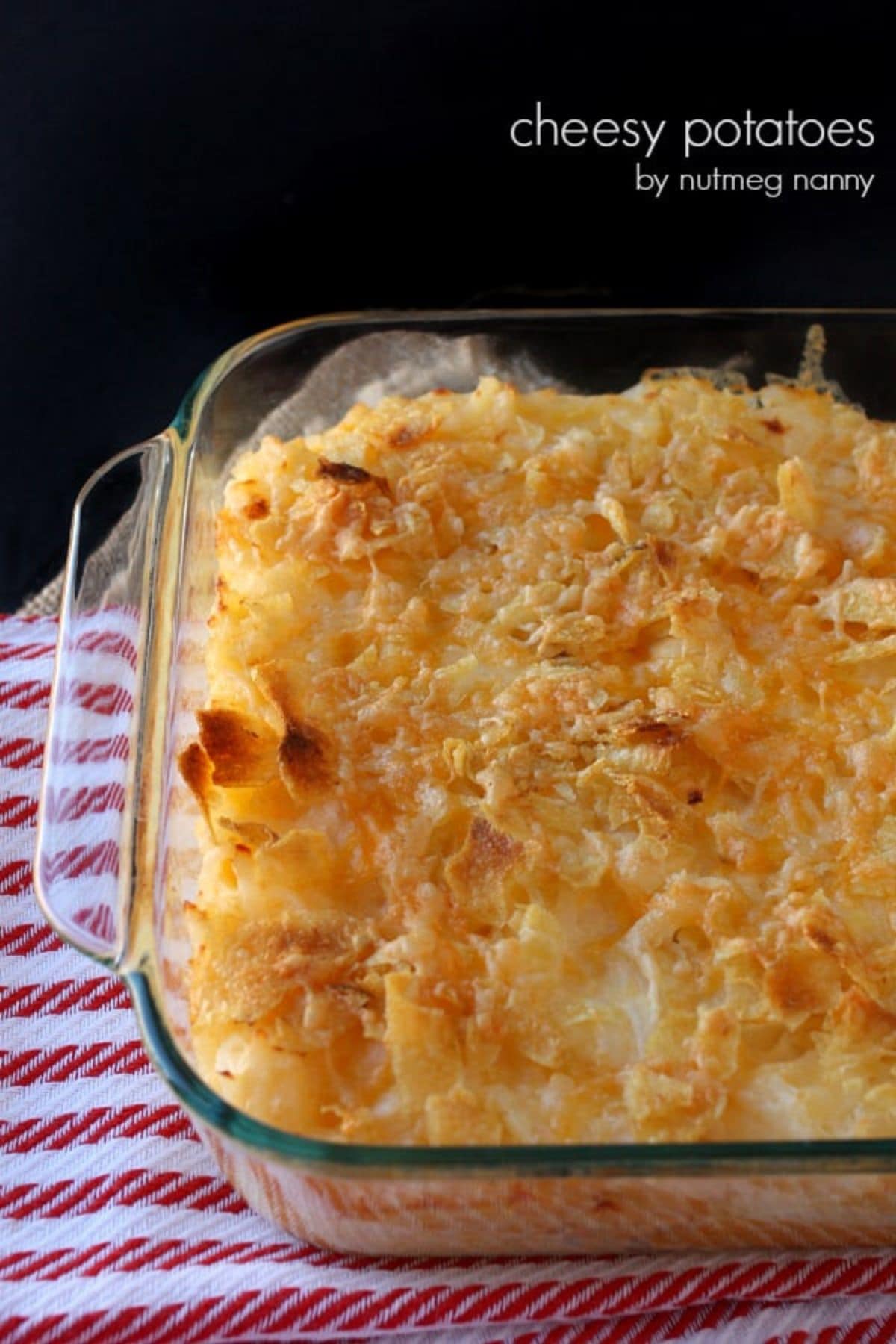 Glass casserole dish filled with cheesy potatoes.