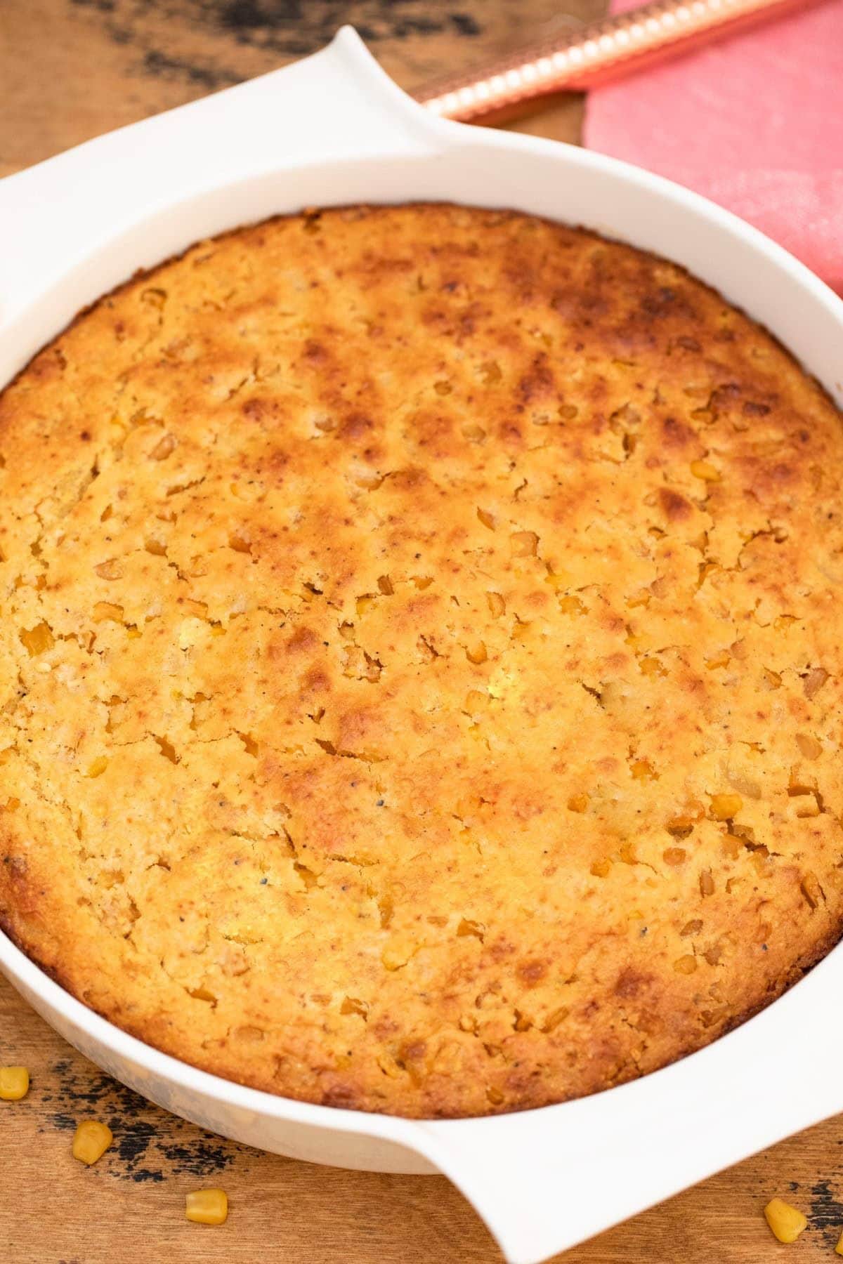 Round casserole dish filled with cornbread casserole.