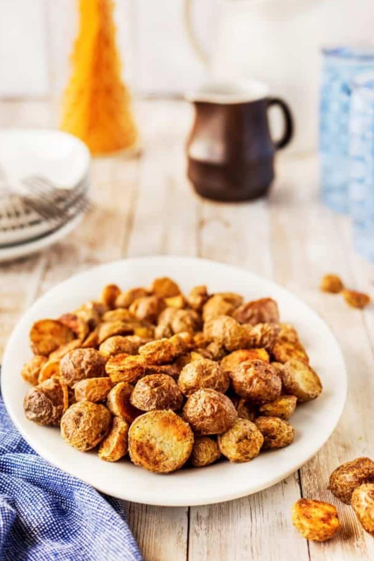 Plate full of crispy roasted potatoes on a counter.