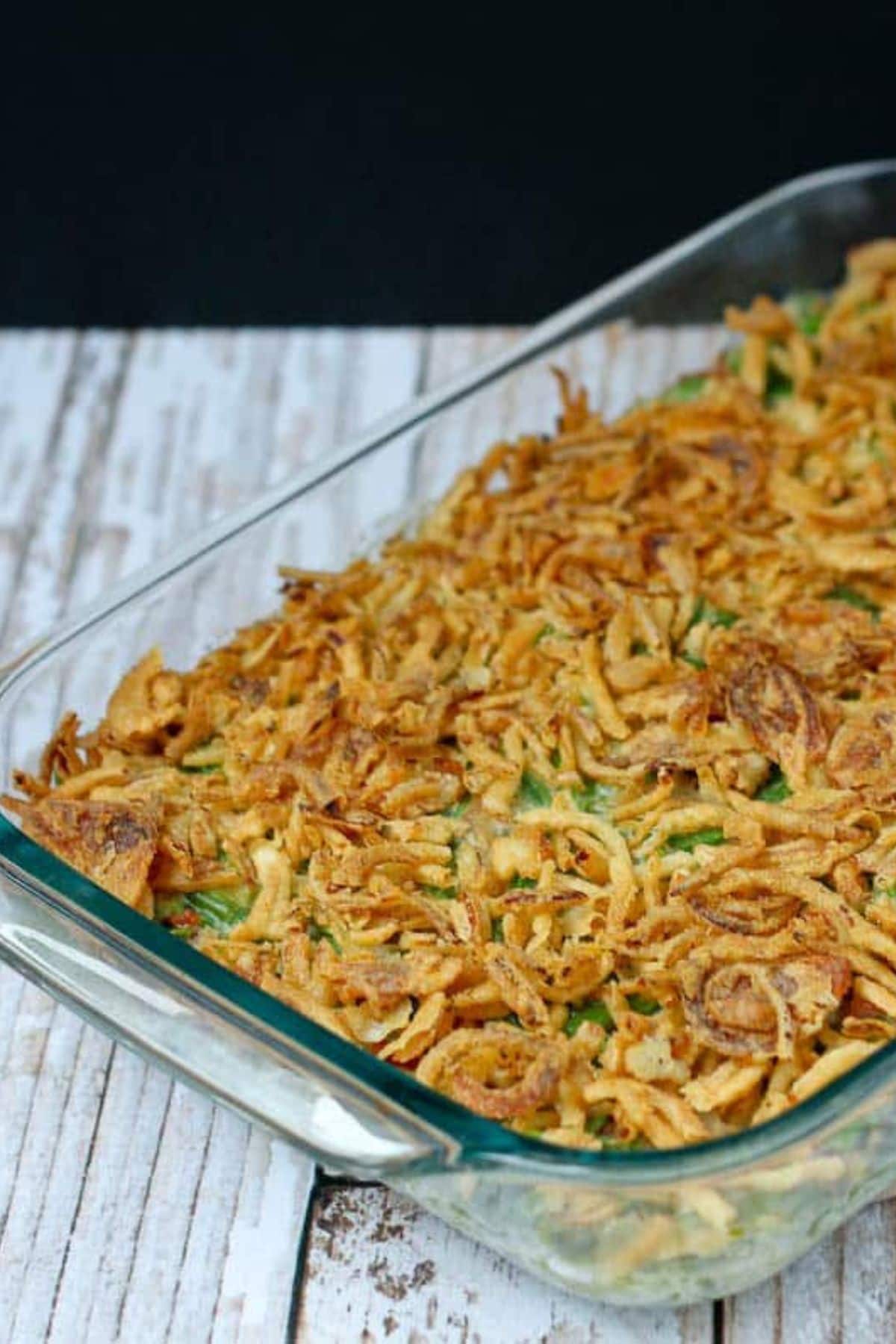 Glass casserole dish filled with green bean casserole.