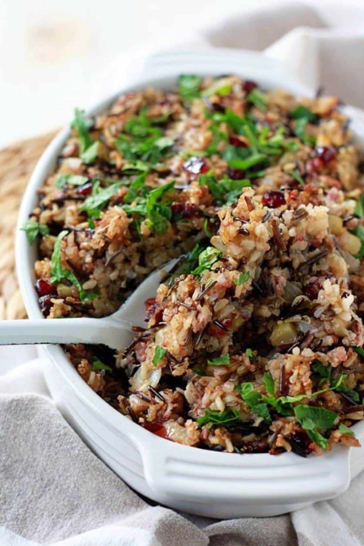 Herbed wild rice and quinoa in a casserole dish, and garnished with fresh parsley.