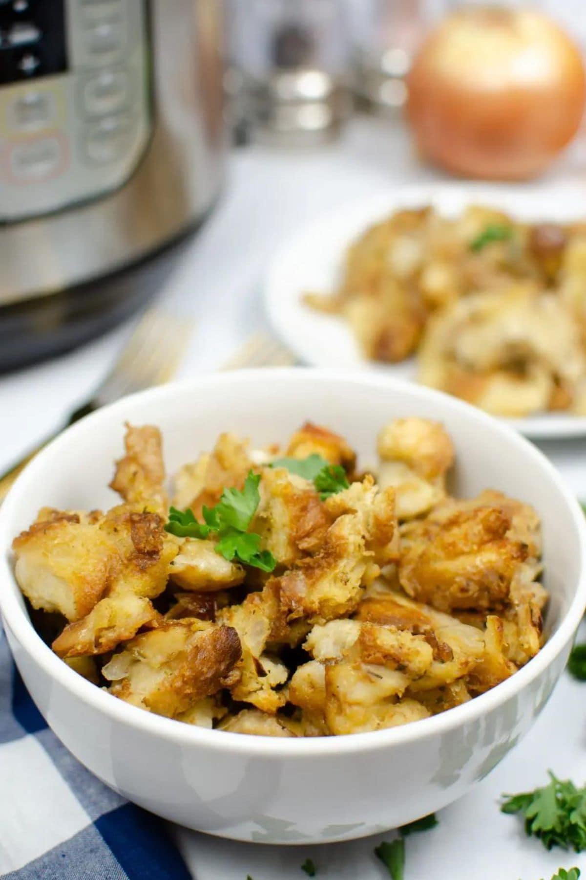 Bowl full of Instant Pot Stuffing ready to serve on a counter.