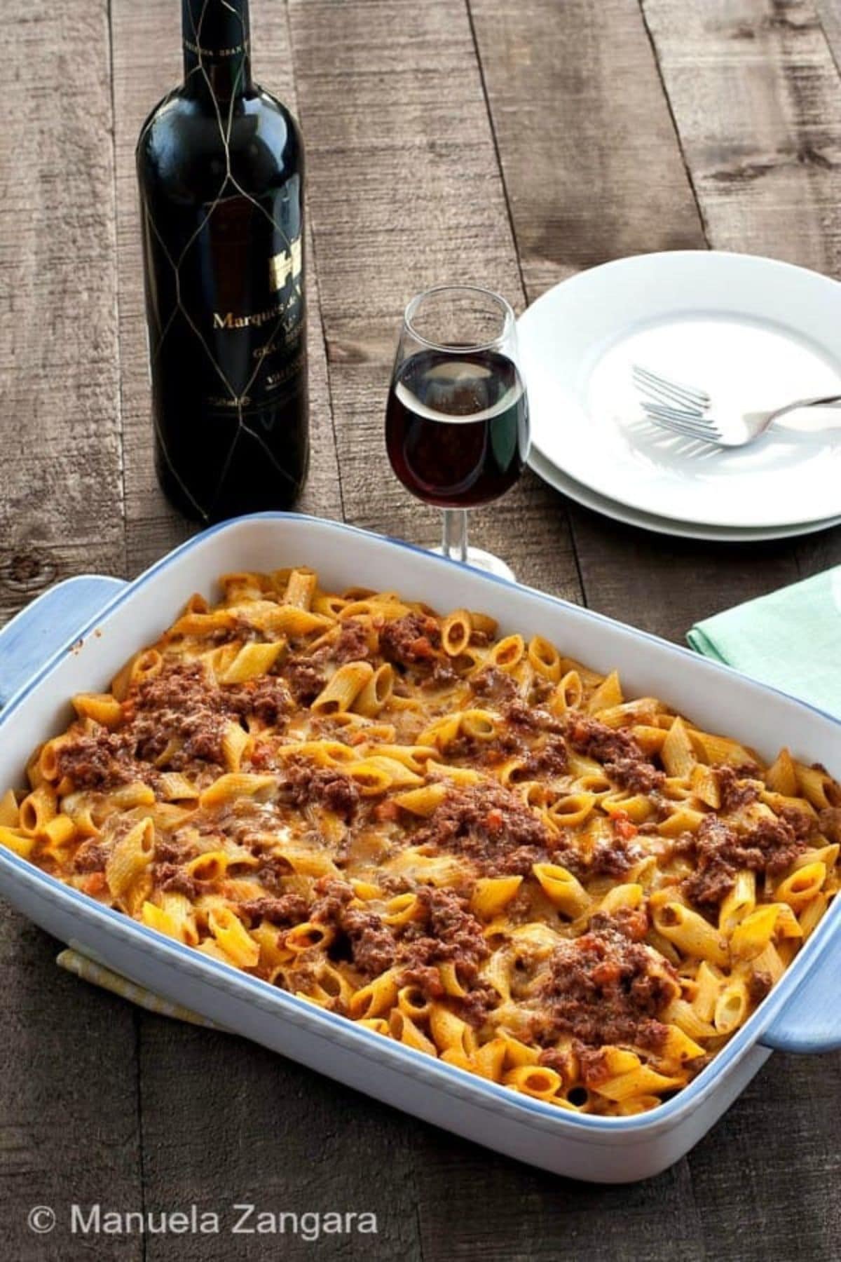 Uncut pasta bake in a casserole dish on a table ready to serve.