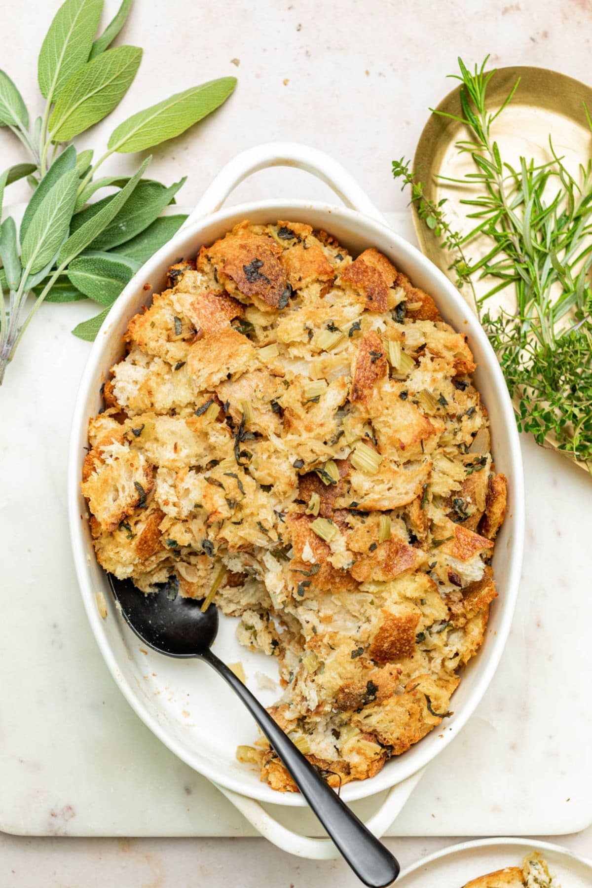 Sourdough Stuffing in a casserole dish with a serving missing.