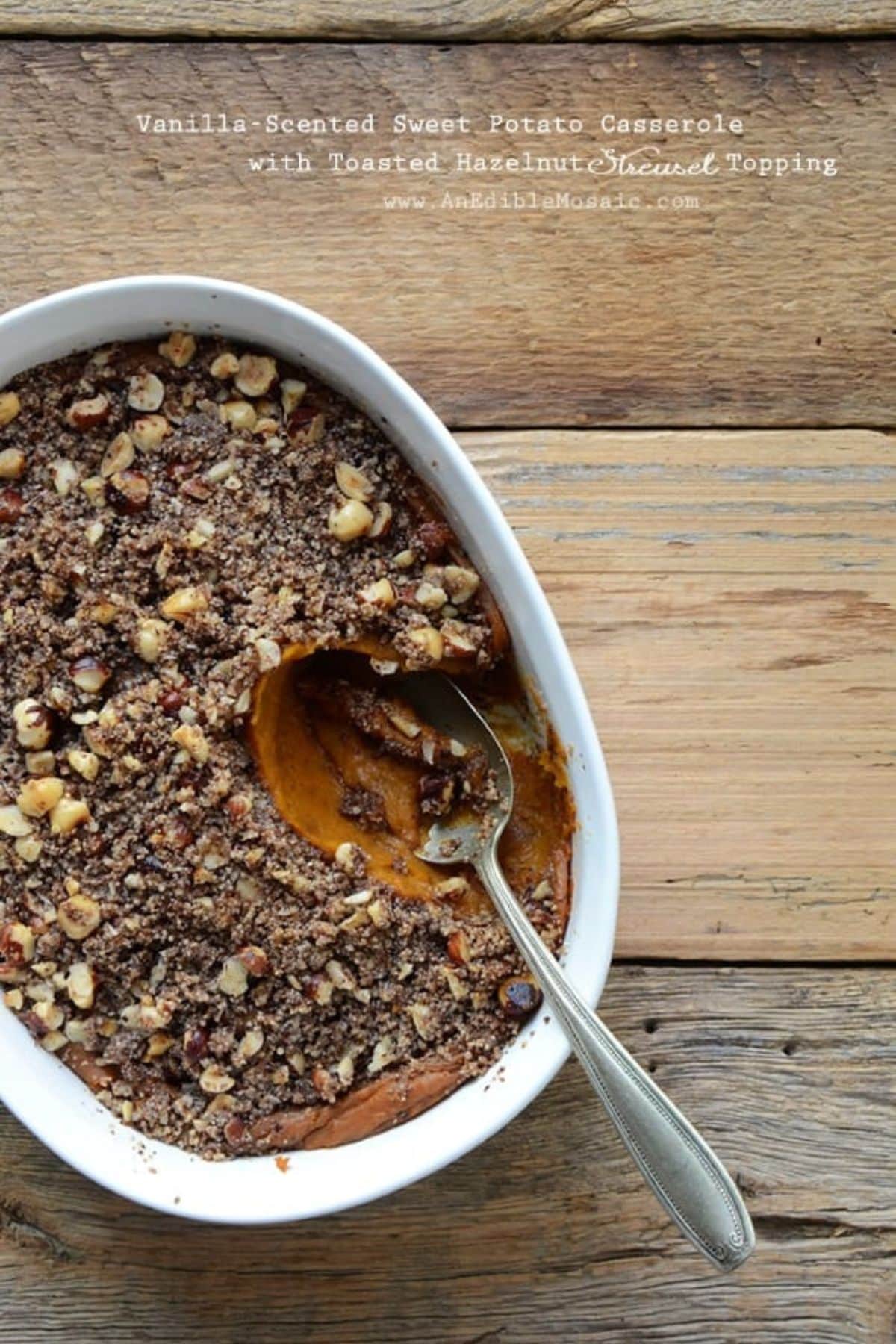 Vanilla hazelnut sweet potato casserole in a baking dish with a spoonful missing from the dish.