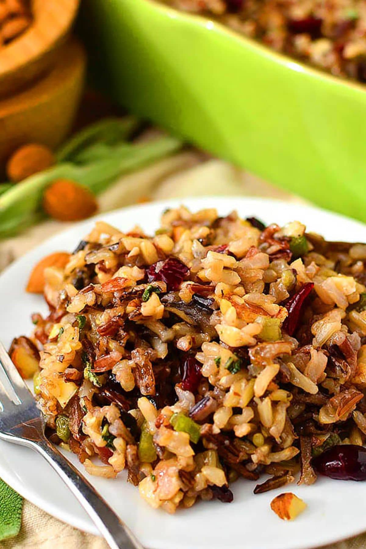 Plate full of wild rice stuffing alongside a fork.