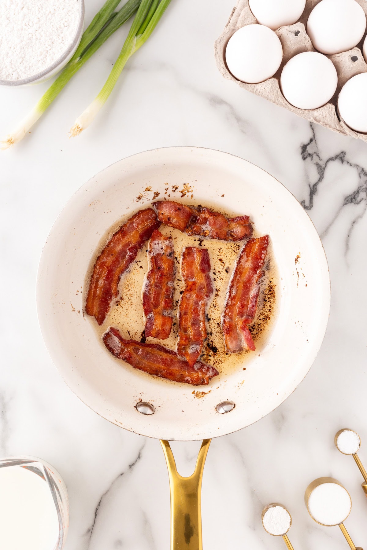 Cooking bacon in a fry pan. 