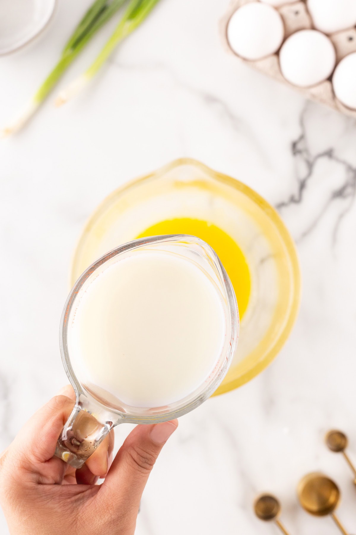 Adding milk to yolks. 