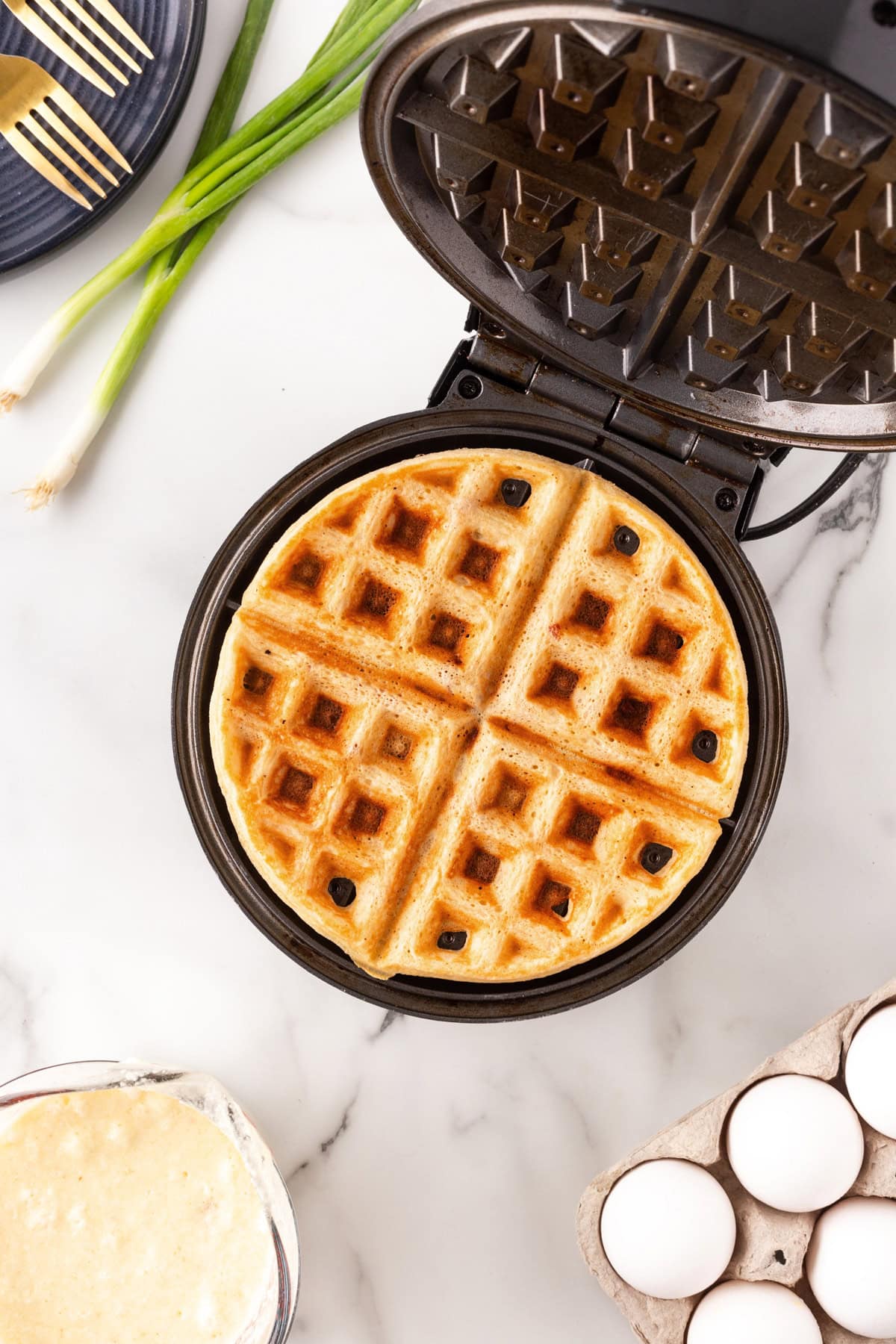 Finished waffle in a waffle iron. 