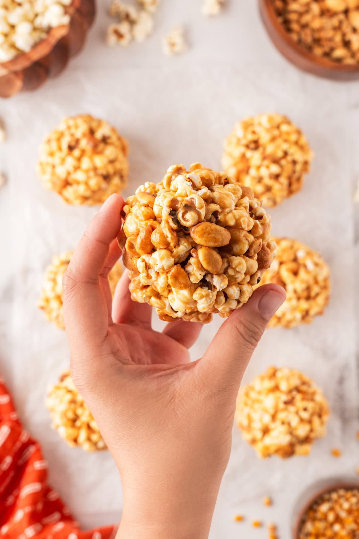 Holding a popcorn ball. 