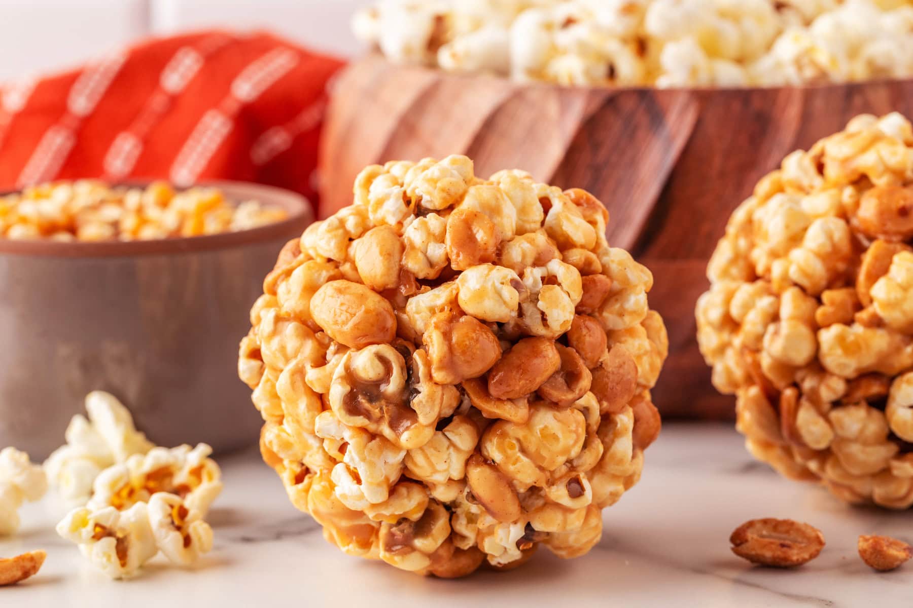 Horizontal picture of a popcorn ball with peanuts. 