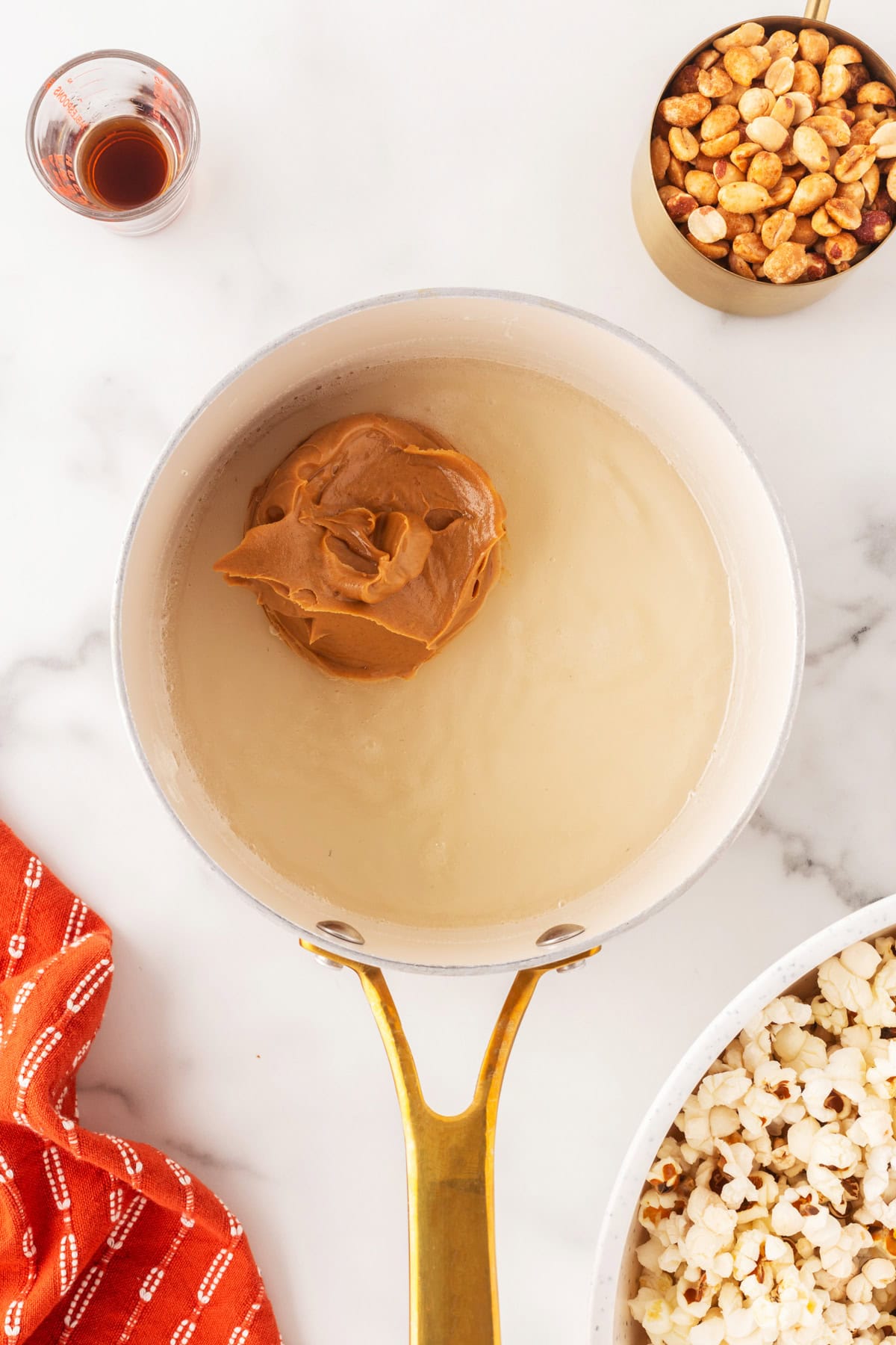 Adding peanut butter to the corn syrup mixture. 