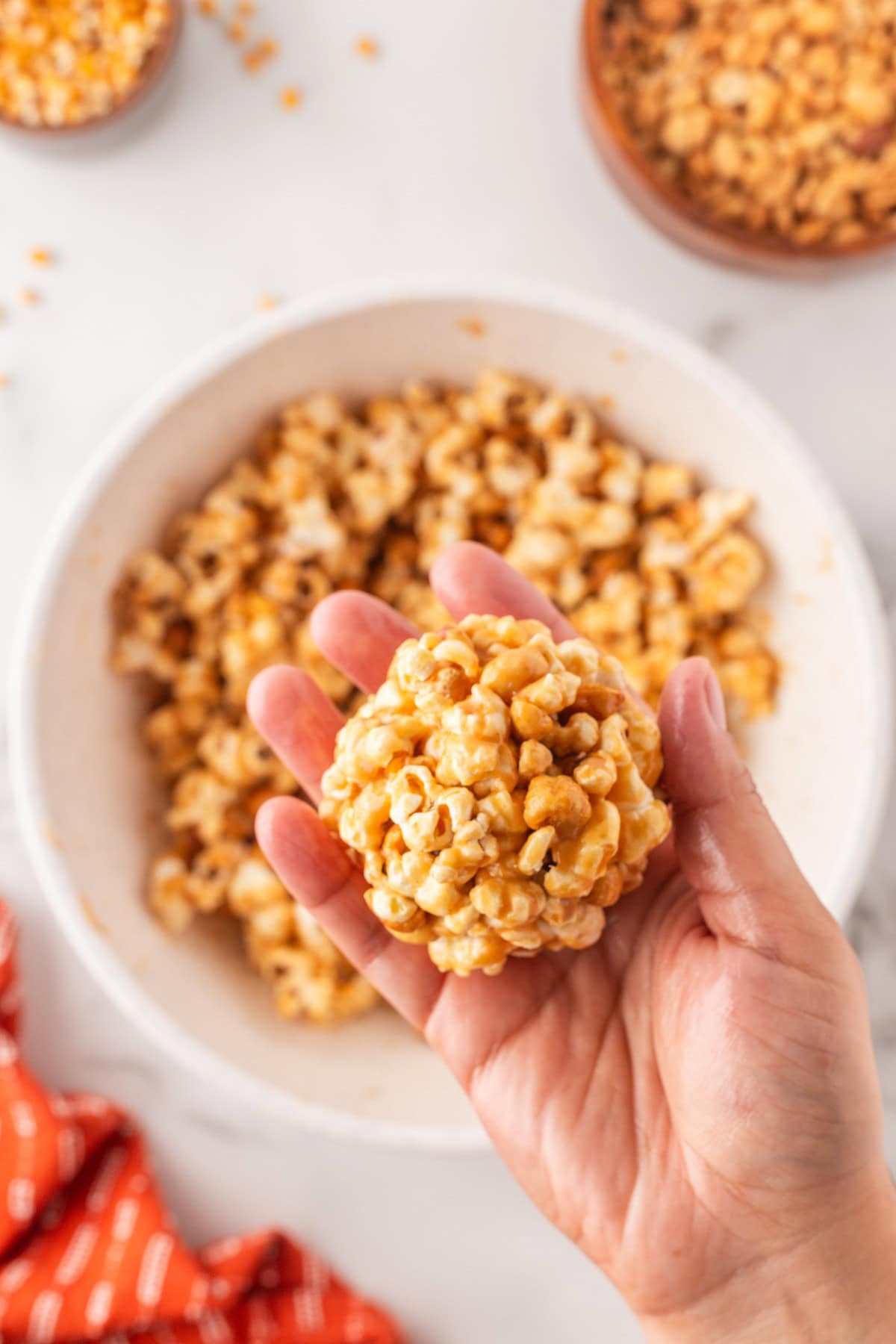 Holding a finished popcorn ball. 