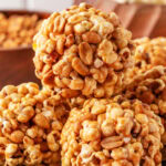 Stacked popcorn balls on a plate.