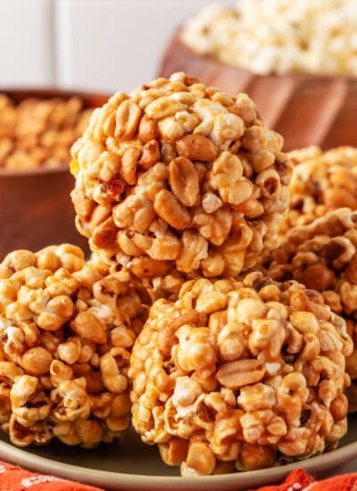 Stacked popcorn balls on a plate.