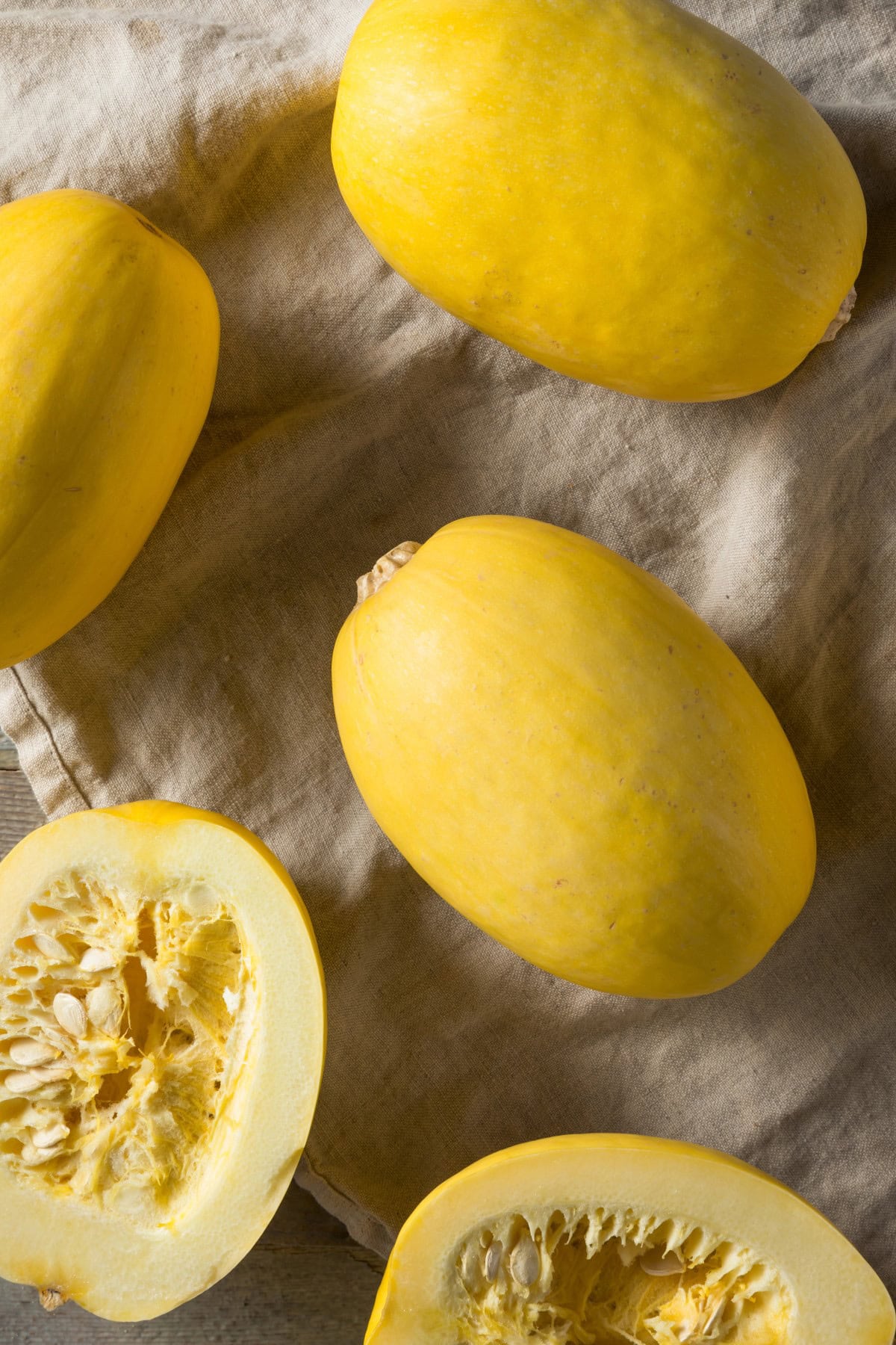 Overhead of spaghetti squash with one cut in half. 