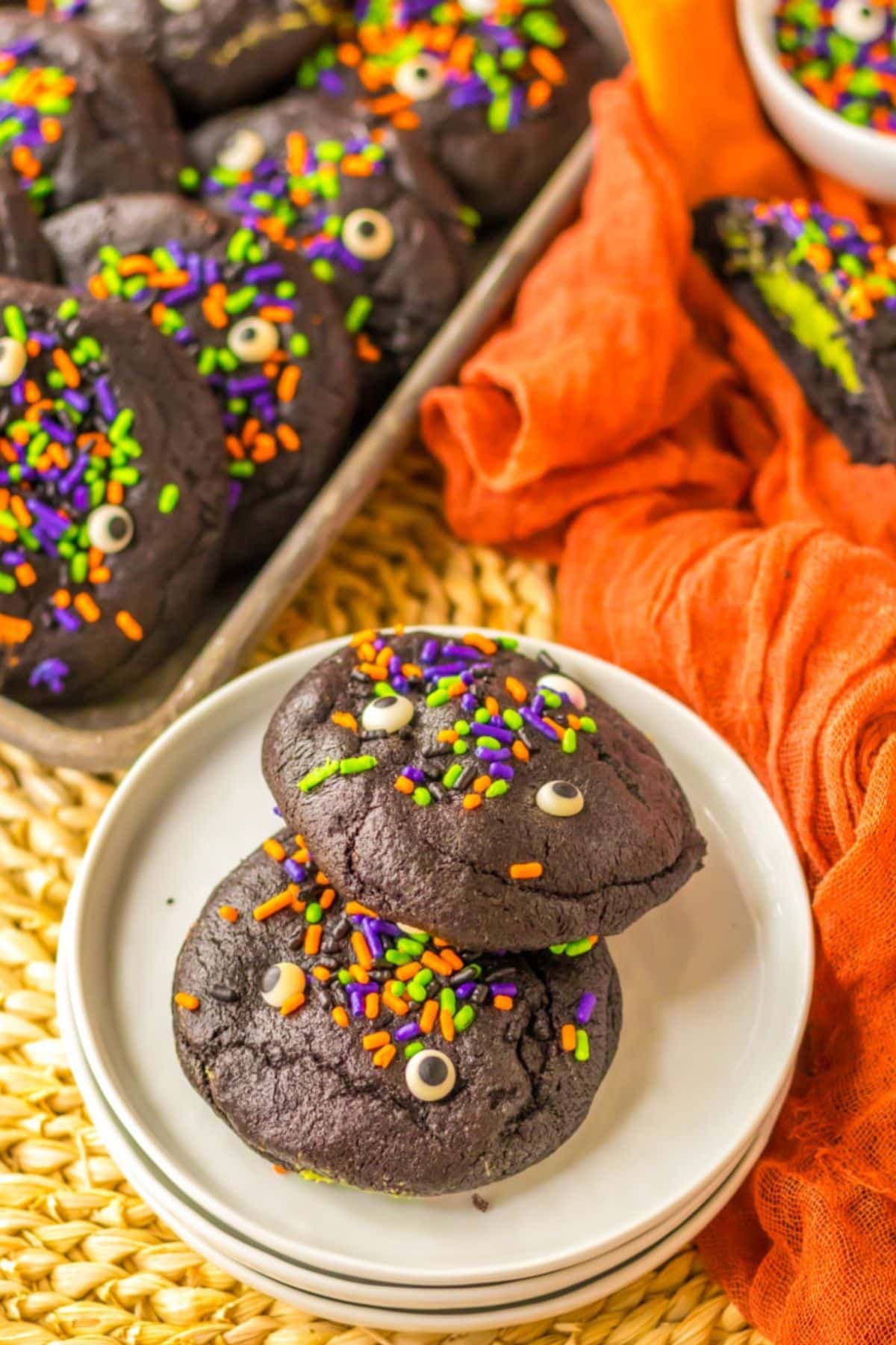 Two black velvet cookies on a small plate.