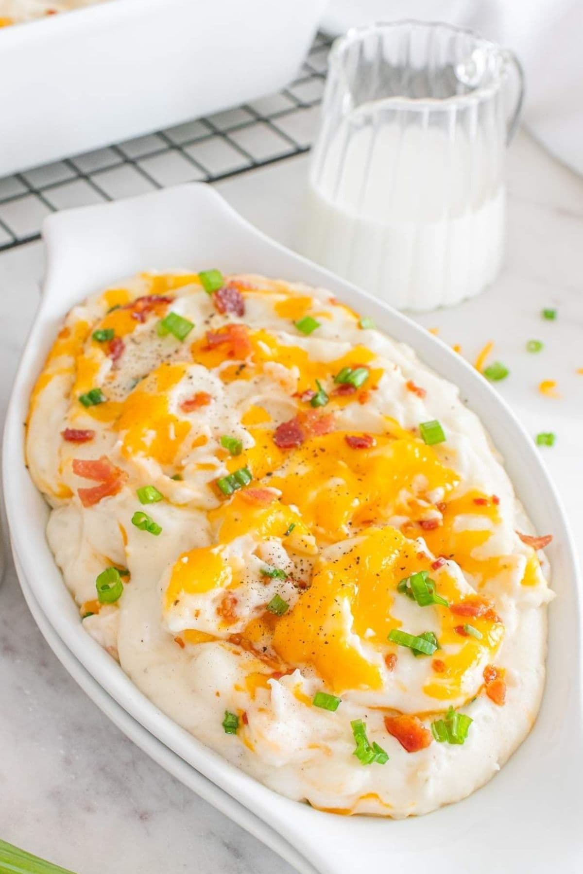 Serving tray filled with loaded mashed potatoes casserole.