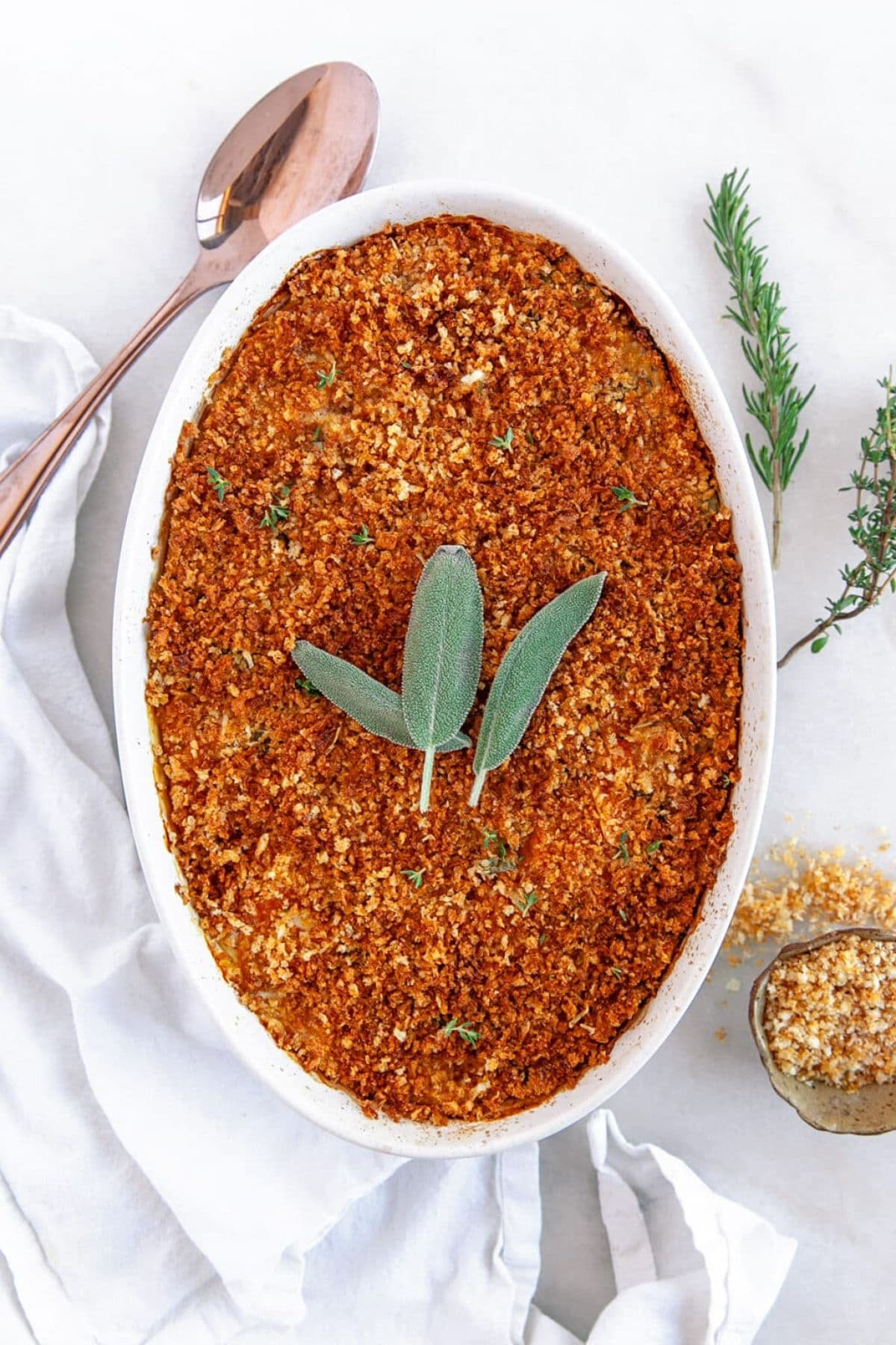 Casseorle dish ful of sweet potato au gratin on a counter ready to serve.