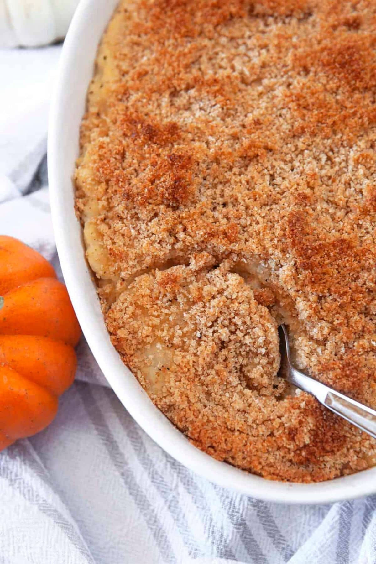 Spoonful of turnip puff being removed from a casserole dish.