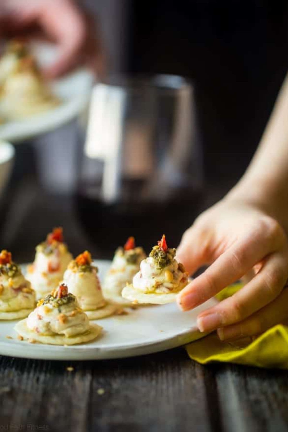 Hummus on crackers on tray.