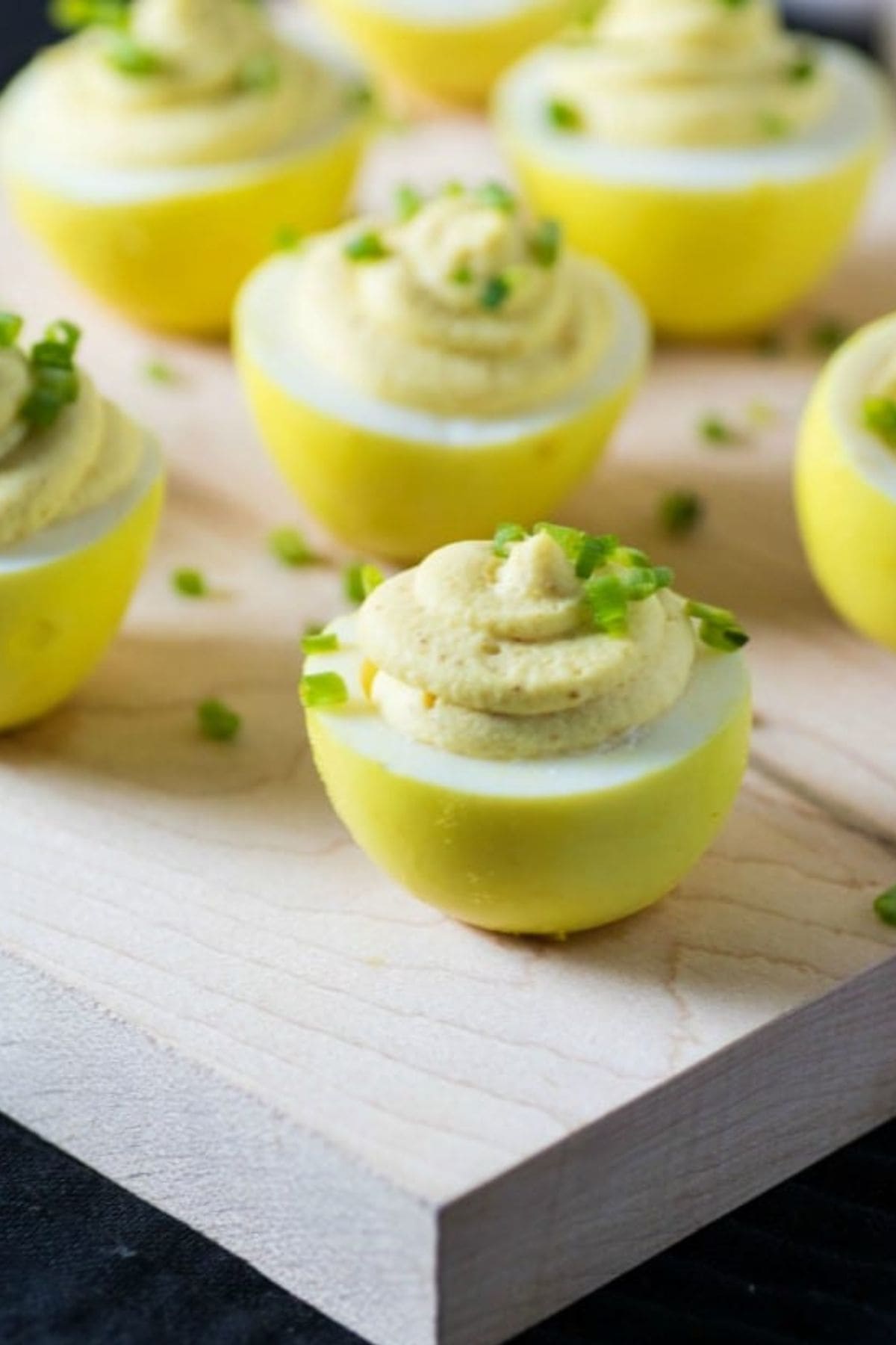 Deviled eggs on cutting board.