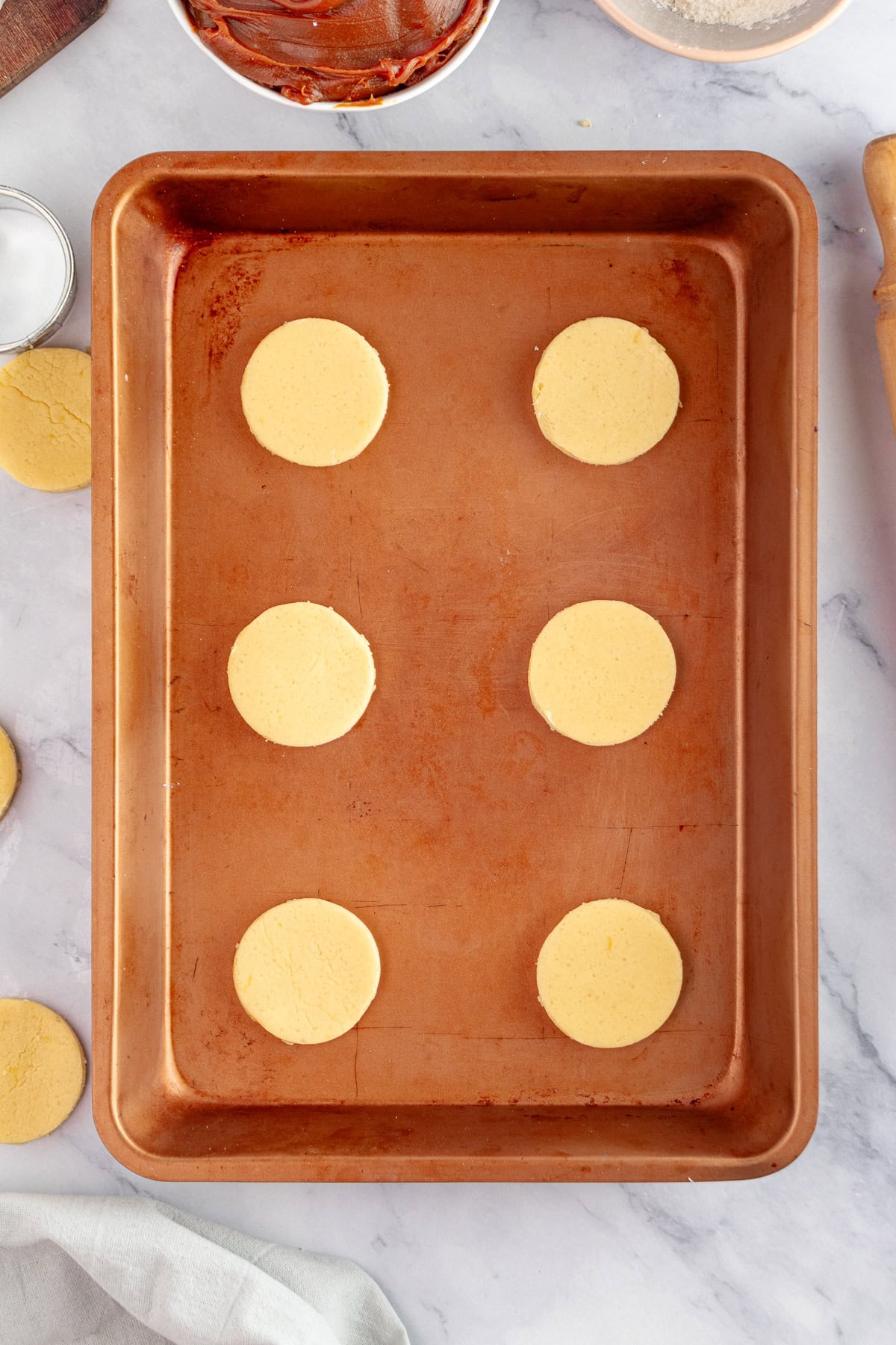 Cookie rounds on a baking sheet. 