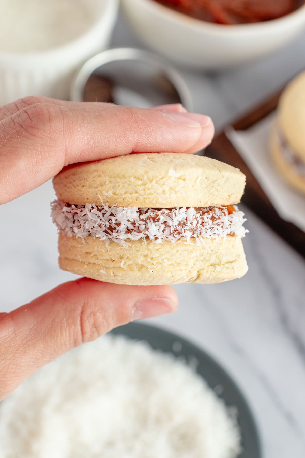 Holding a finished cookie. 