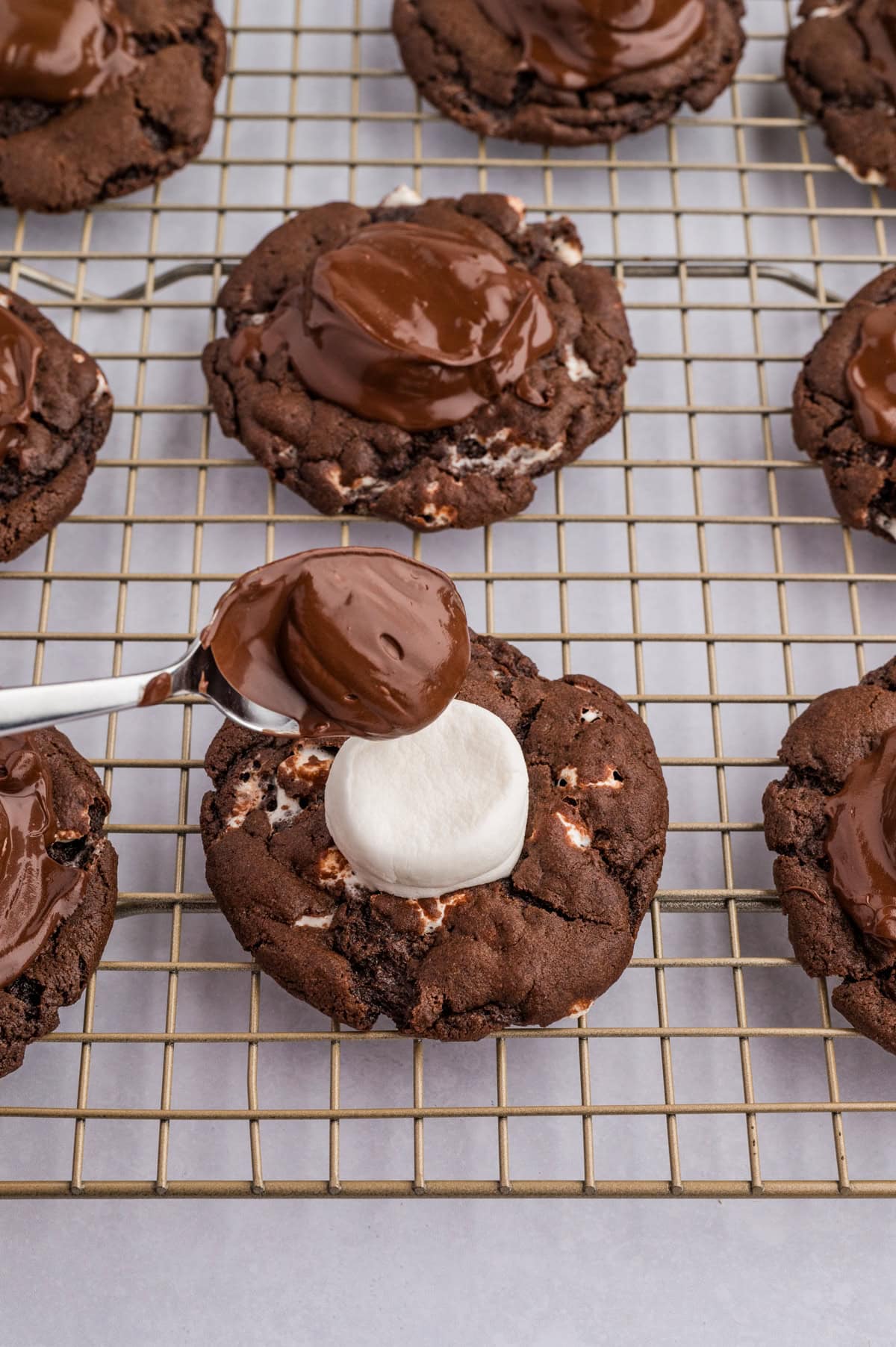 Topping the marshmallow with chocolate. 