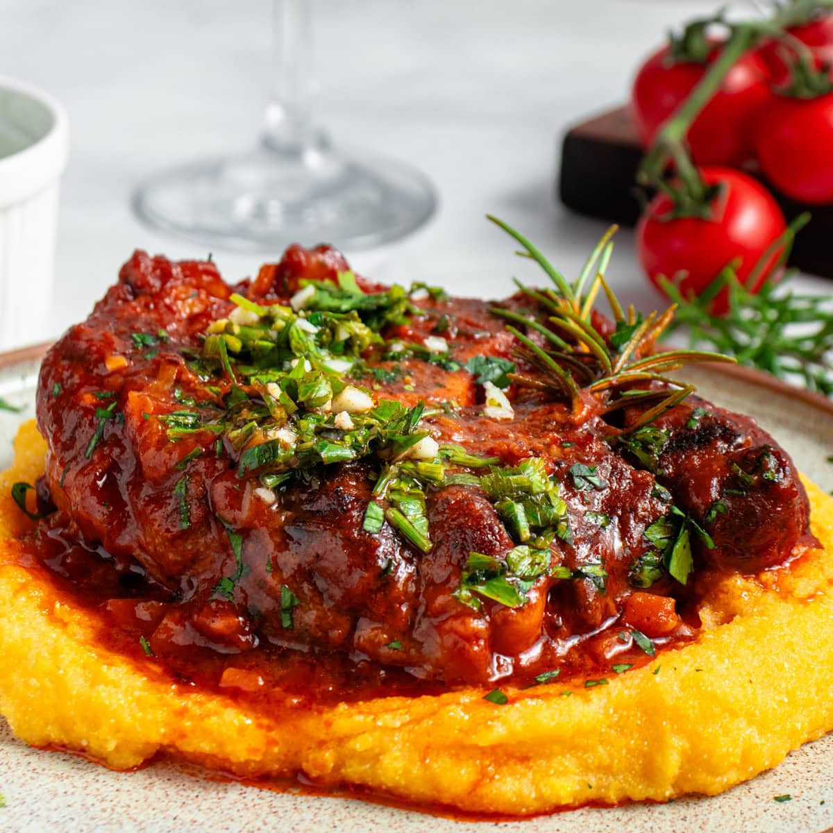 Osso Buco served with polenta and gremolata.