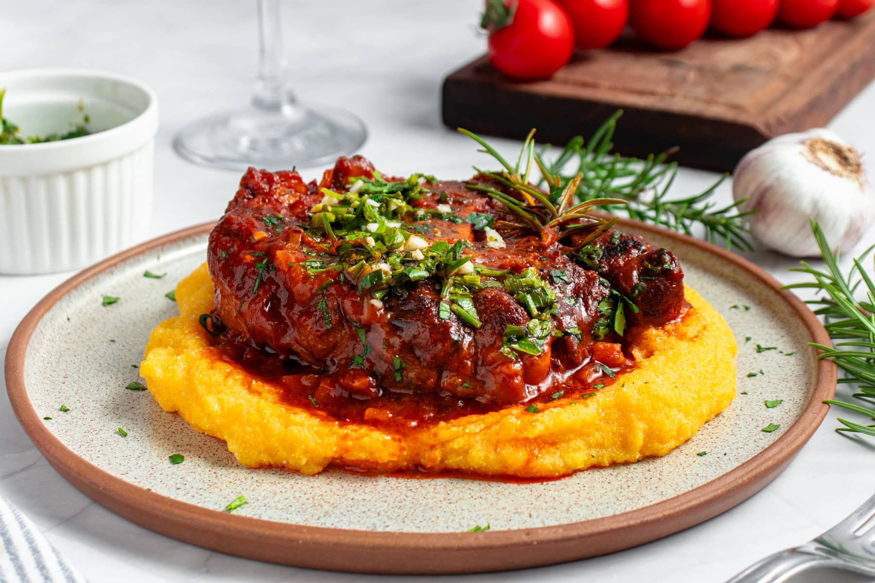 Osso Buco served with polenta and gremolata.