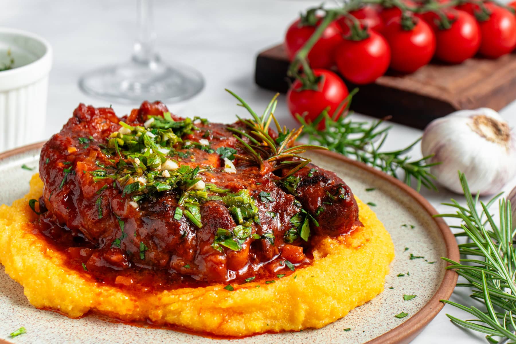 Osso Buco served with polenta and gremolata.