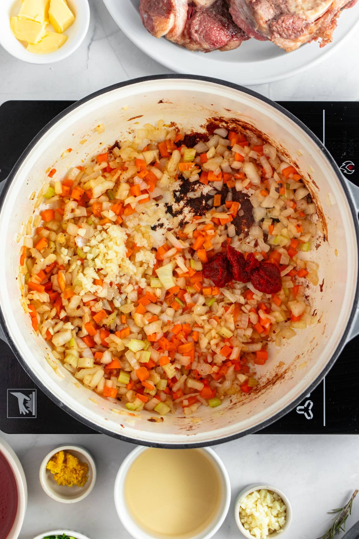 Adding tomato paste and garlic.