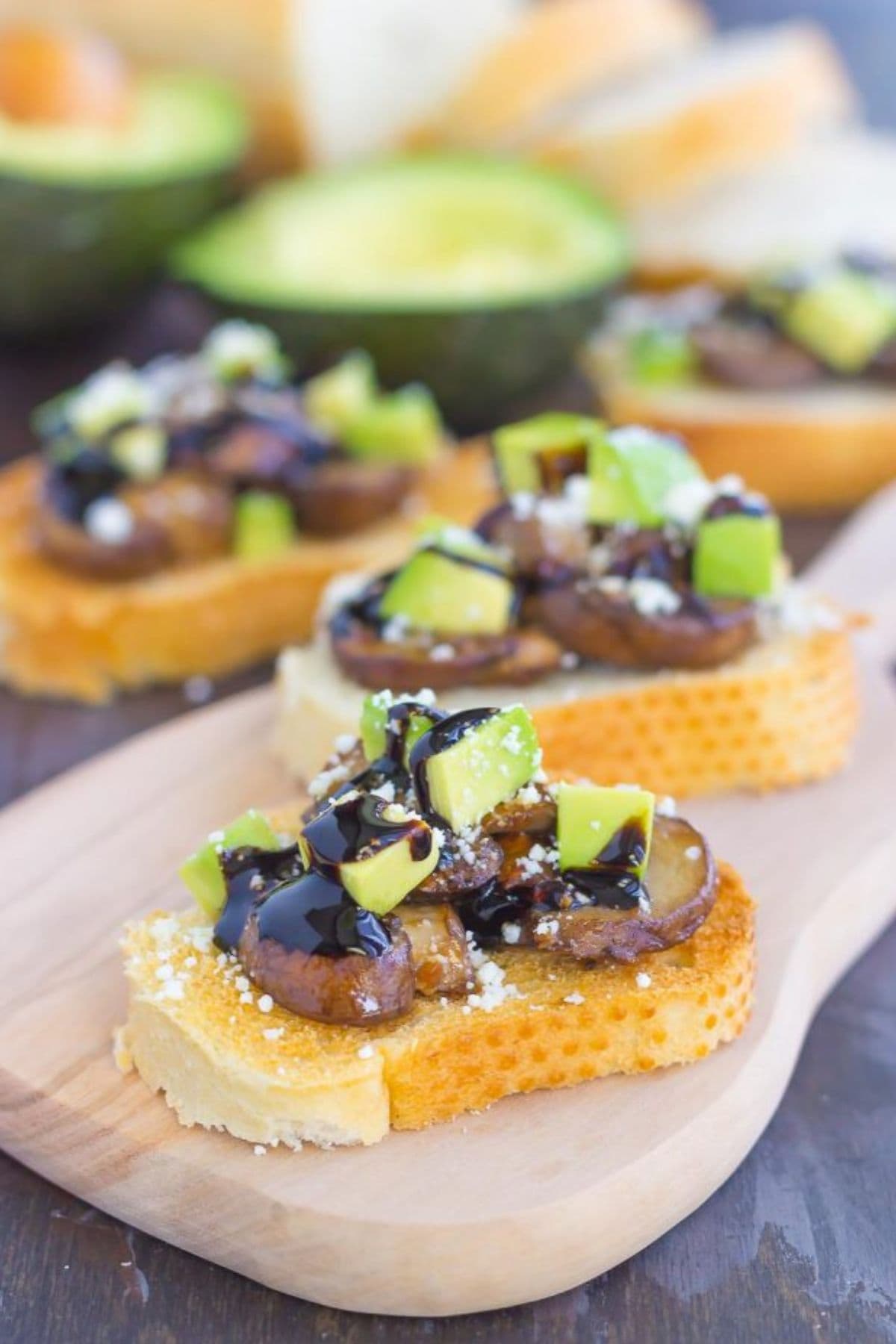 Avocado feta toast on a cutting board.