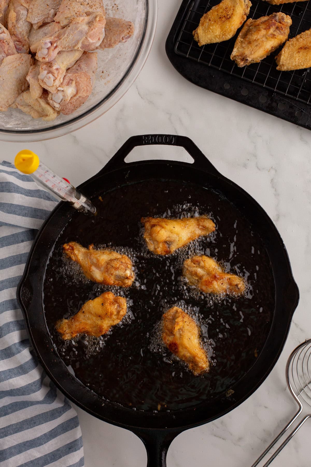 Frying wings in hot oil. 