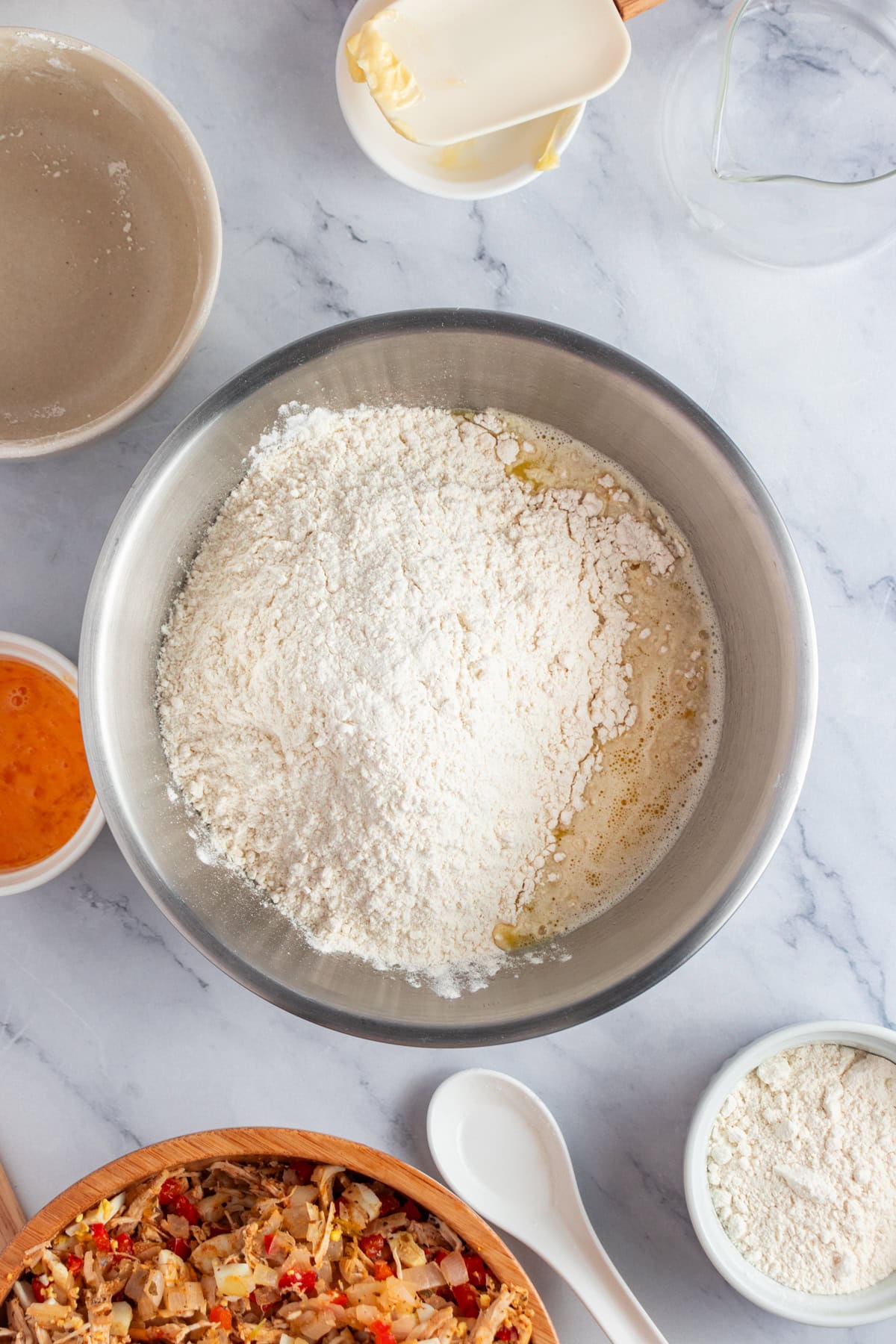 Adding flour and salt to a bowl.