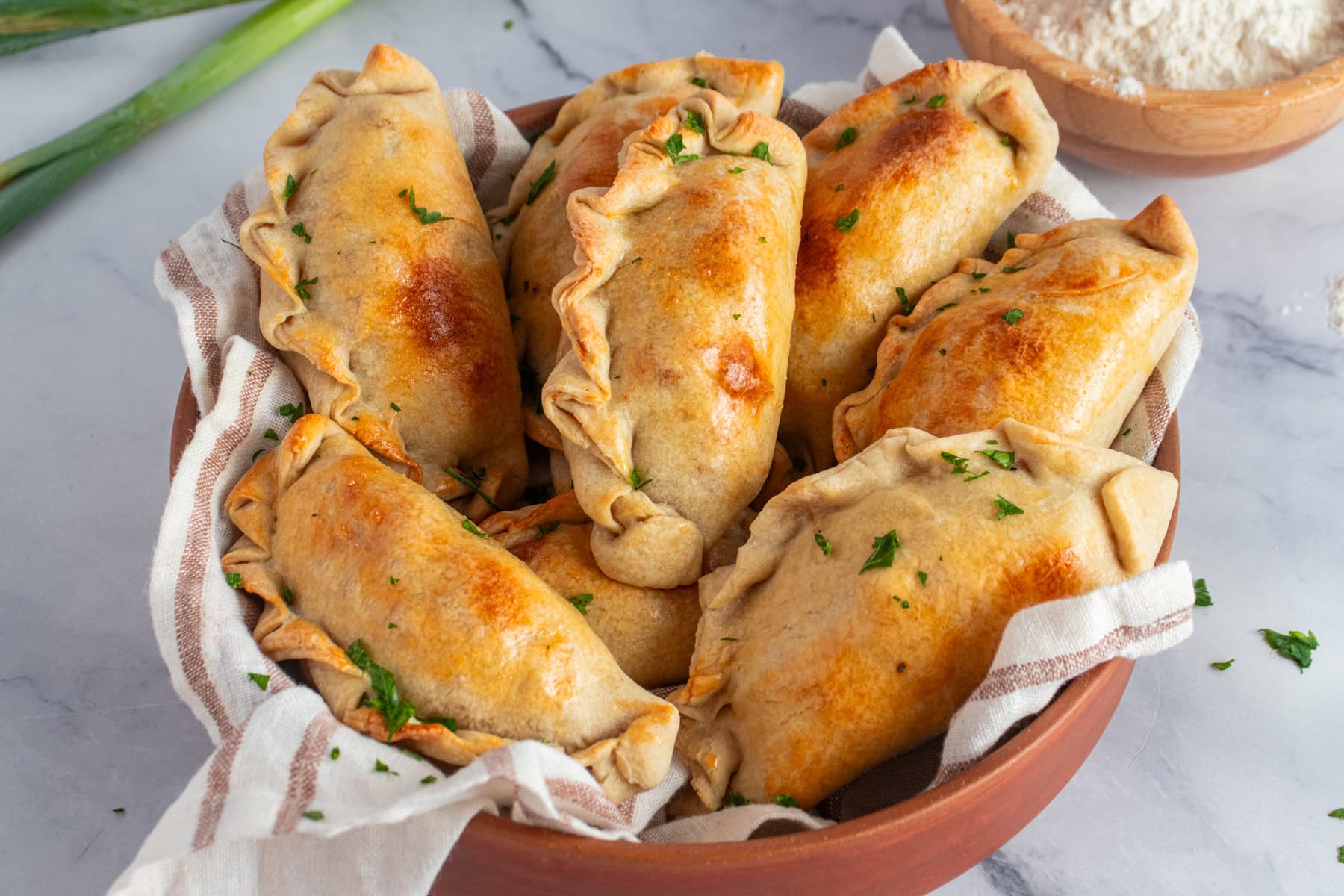 Chicken empanadas in a serving dish.