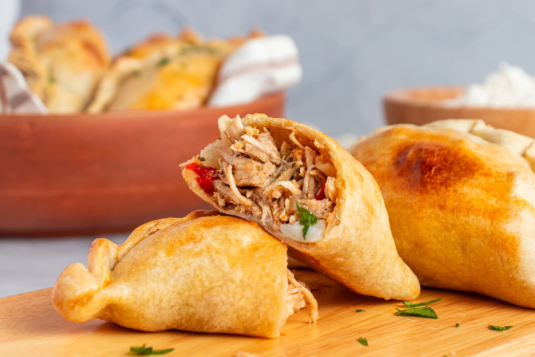 Halved chicken empanada.