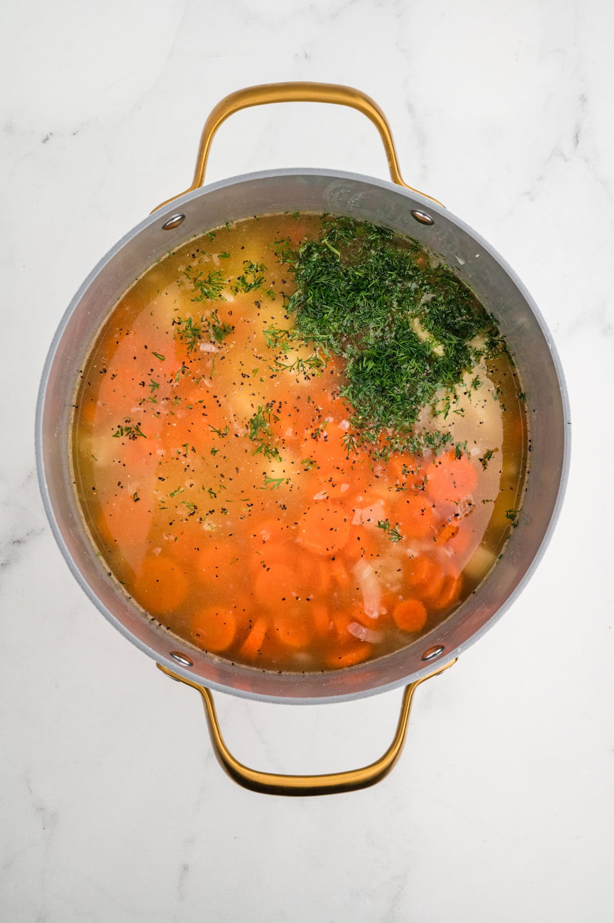 Broth, vegetables and herbs added.