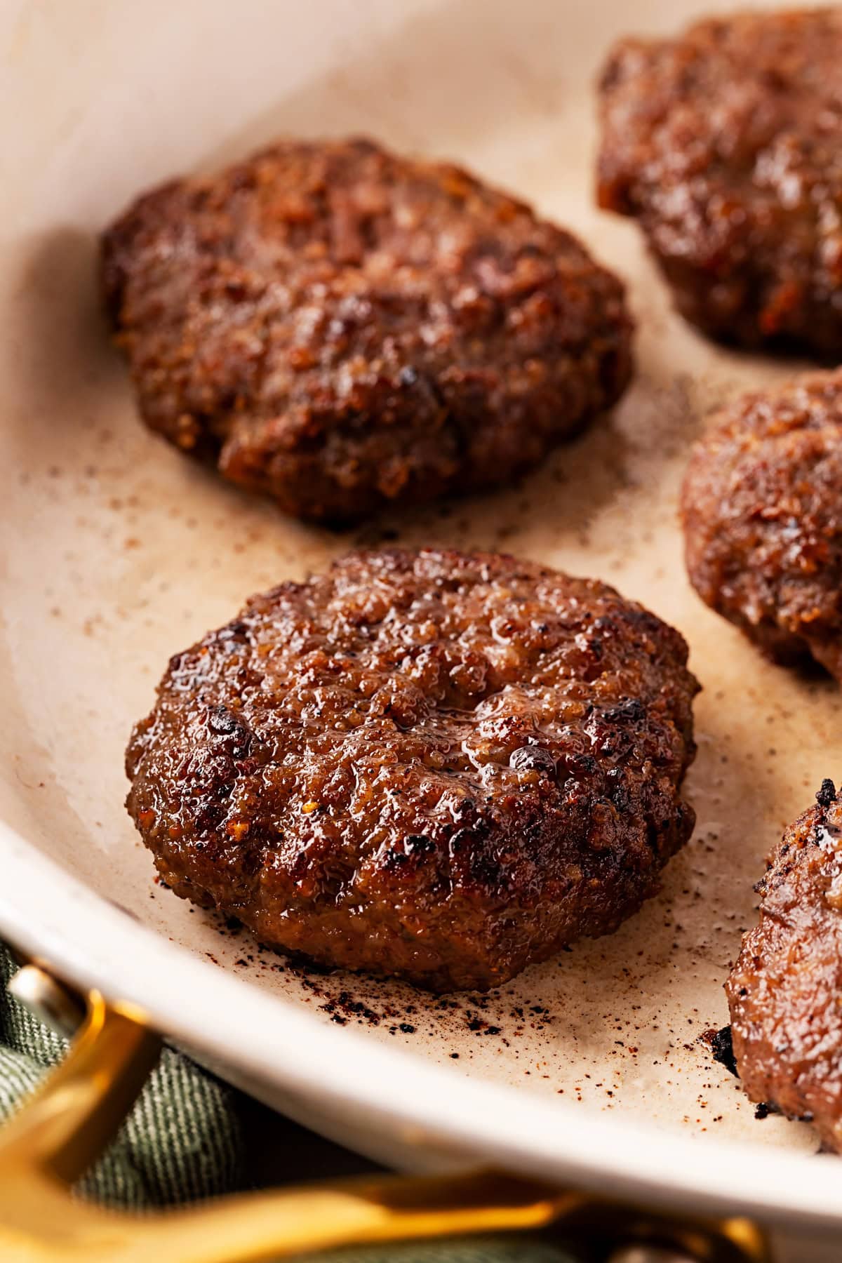 Close-up of patties in a pan. 