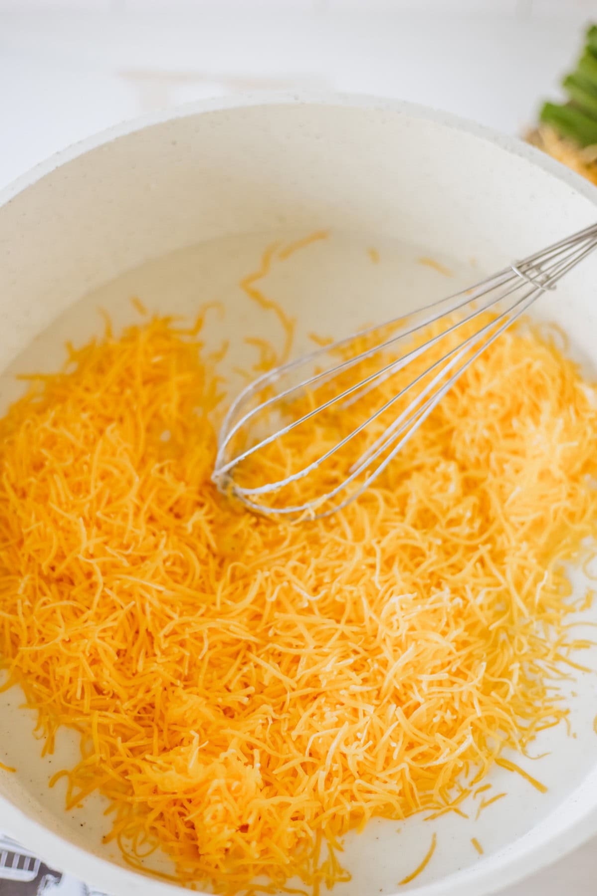 Adding shredded cheese. 