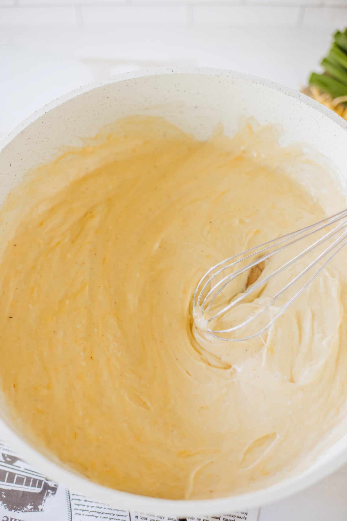 Finished cheese sauce with whisk.