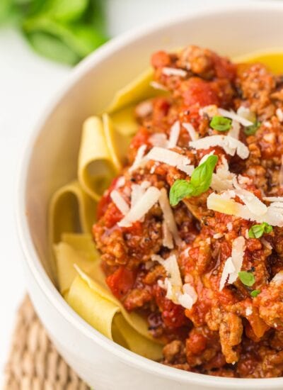 Bowl of pasta with sauce.