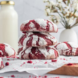 Red velvet crinkle cookies in a wooden board.