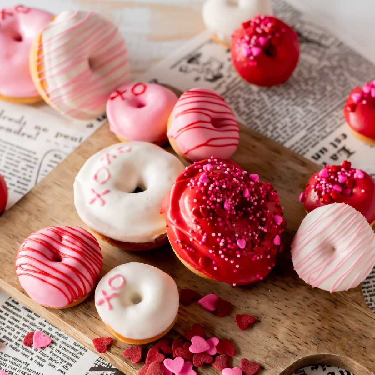 Valentine's Day Donuts on wooden board.