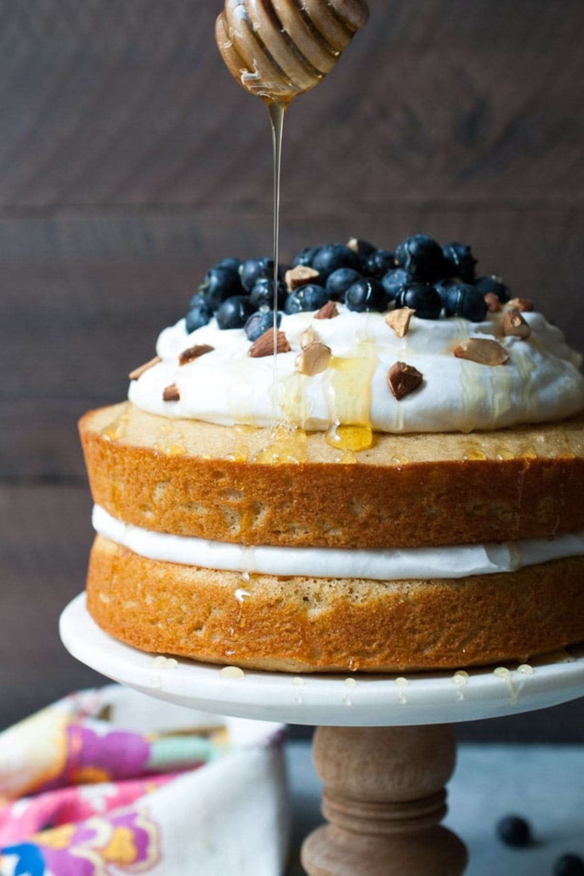 Lemon olive cake on a cake stand.